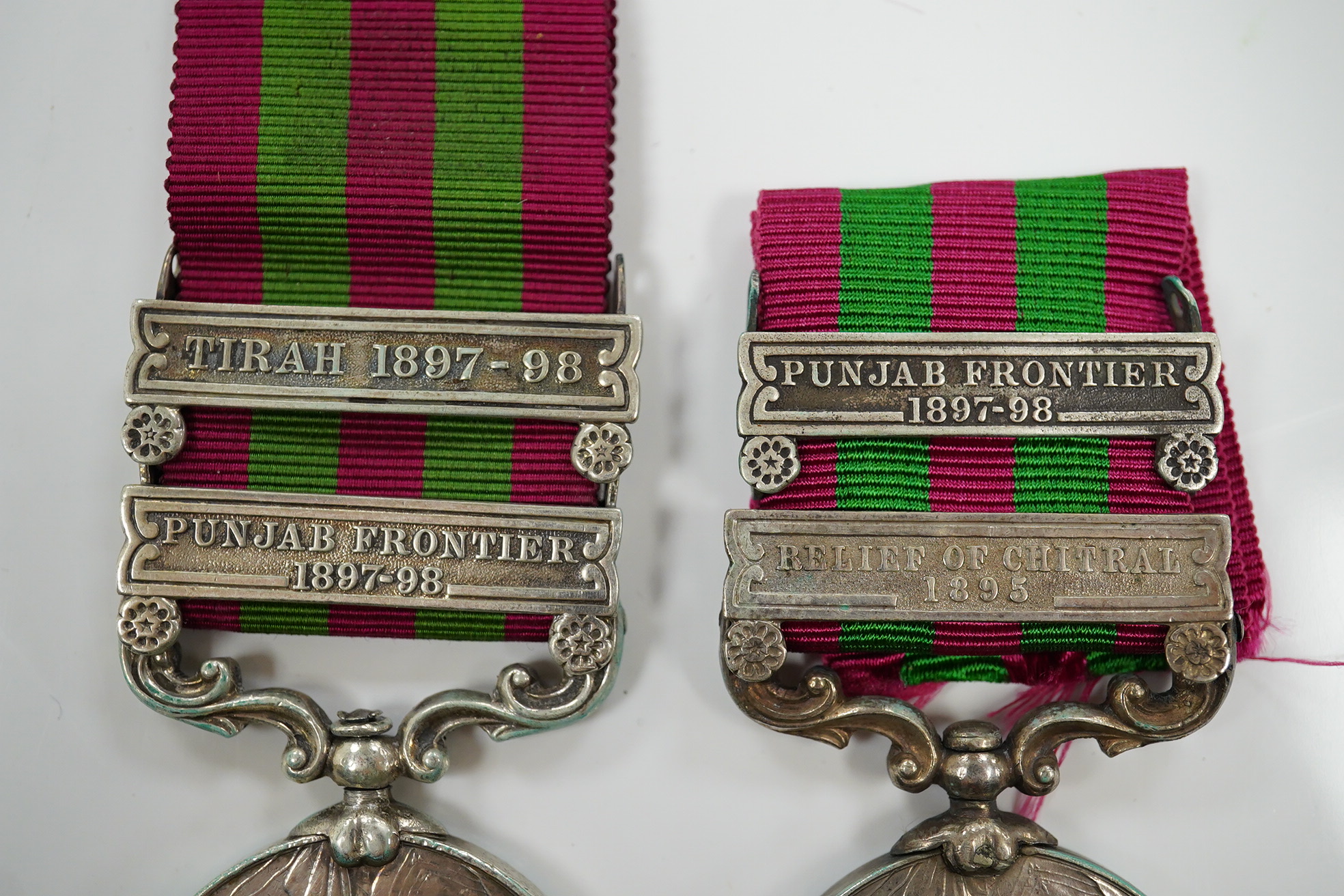 Two India Medals; one with Punjab Frontier 1897-98 and Relief of Chitral 1895 clasps, the other Tirah 1897-98 and Punjab Frontier 1897-98, both with naming erased.